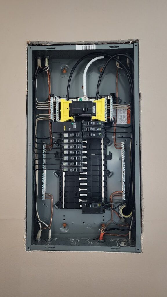 Newly replaced residential electrical panel with a 200-amp main breaker and neatly organized circuits, installed by Flat River Electric in West Michigan.