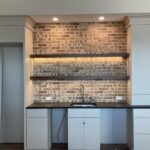 Low-voltage accent lighting above a brick fireplace