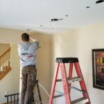 Flat River Electric technician installing recessed lighting during a home remodel