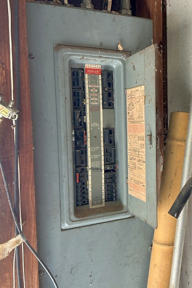 Original Federal Pacific Stab-Lok electrical panel with a handwritten circuit legend in a Forest Hills, Michigan home