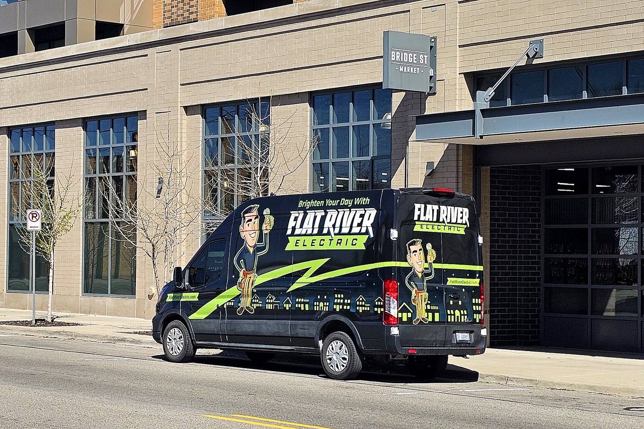 Flat River Electric service van parked on Bridge Street in Grand Rapids, Michigan