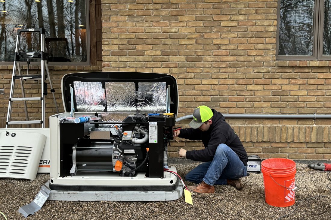 Flat River Electric electrician wiring a Generac home standby generator during installation