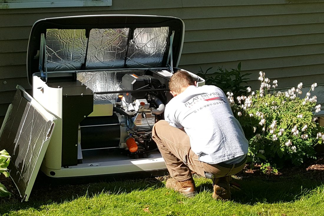 Flat River Electric technician servicing an open Generac home standby generator